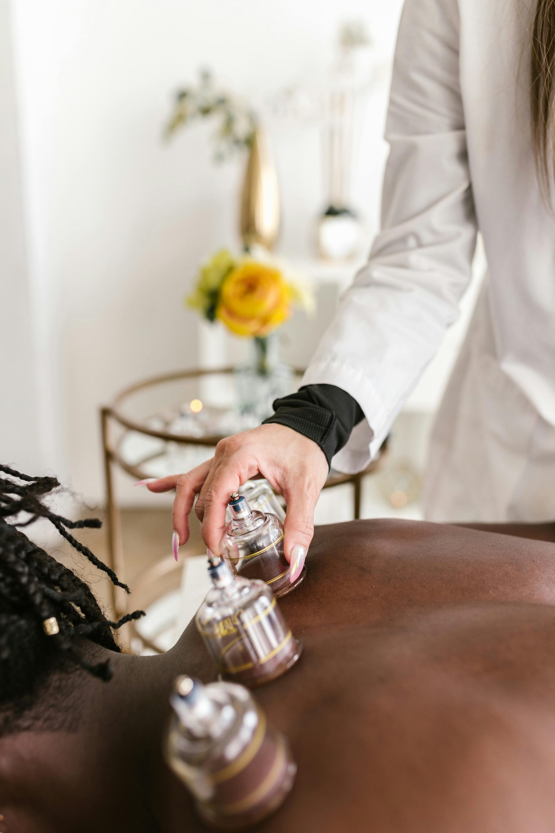 A Therapist Putting Suction on a Person's Back